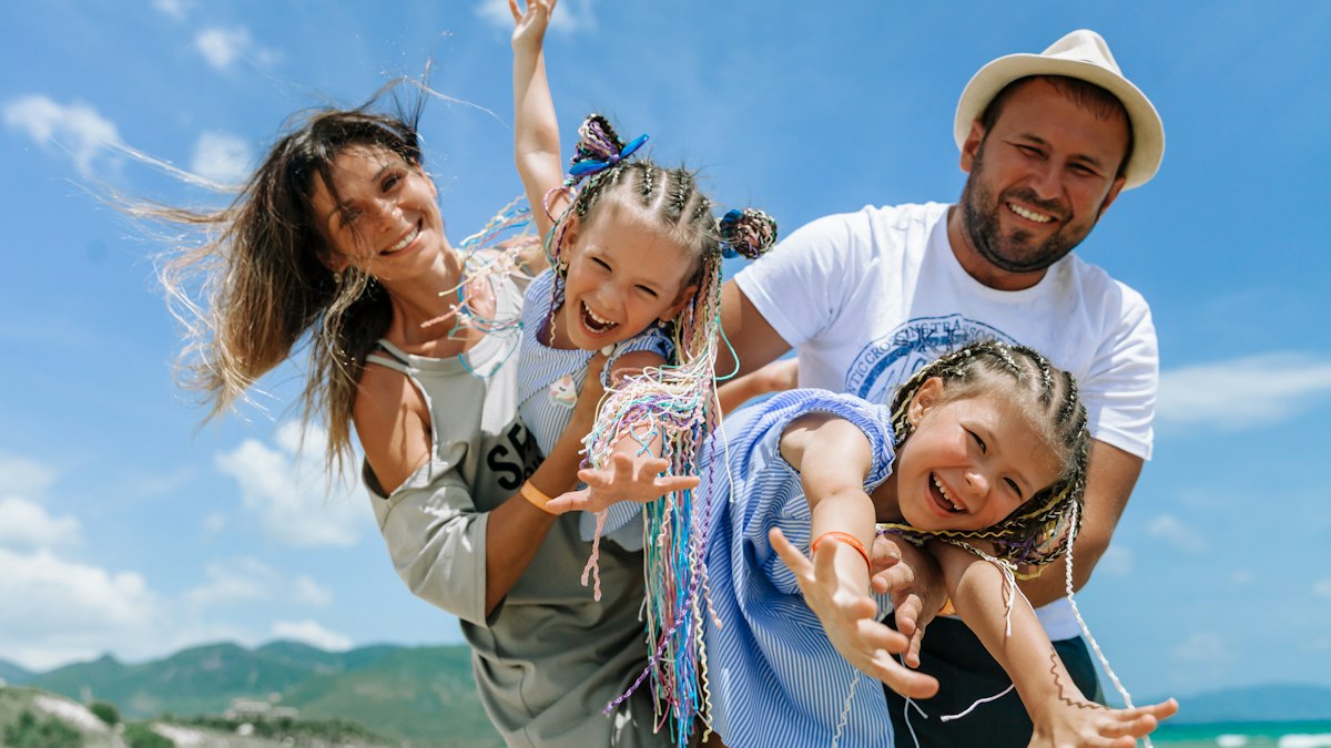 Happy family enjoying a sunny day at the beach